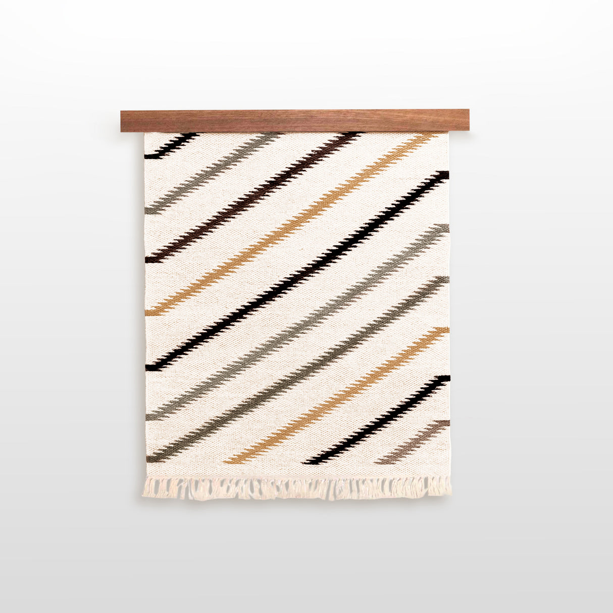 The Promin (Beam) Wool Rug / Wall Hanging features handwoven diagonal stripes in brown, gold, and gray on cream Carpathian mountain sheeps wool with bottom fringe—ideal for adding texture to your gallery wall.