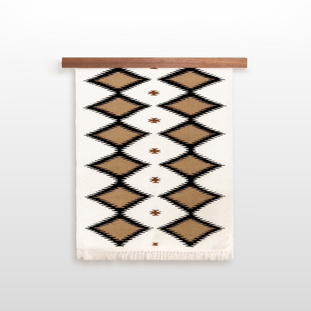 Handmade in Ukraine, this organic 100% sheep wool wall hanging features brown and black diamond patterns on white and is displayed on a wooden rod.