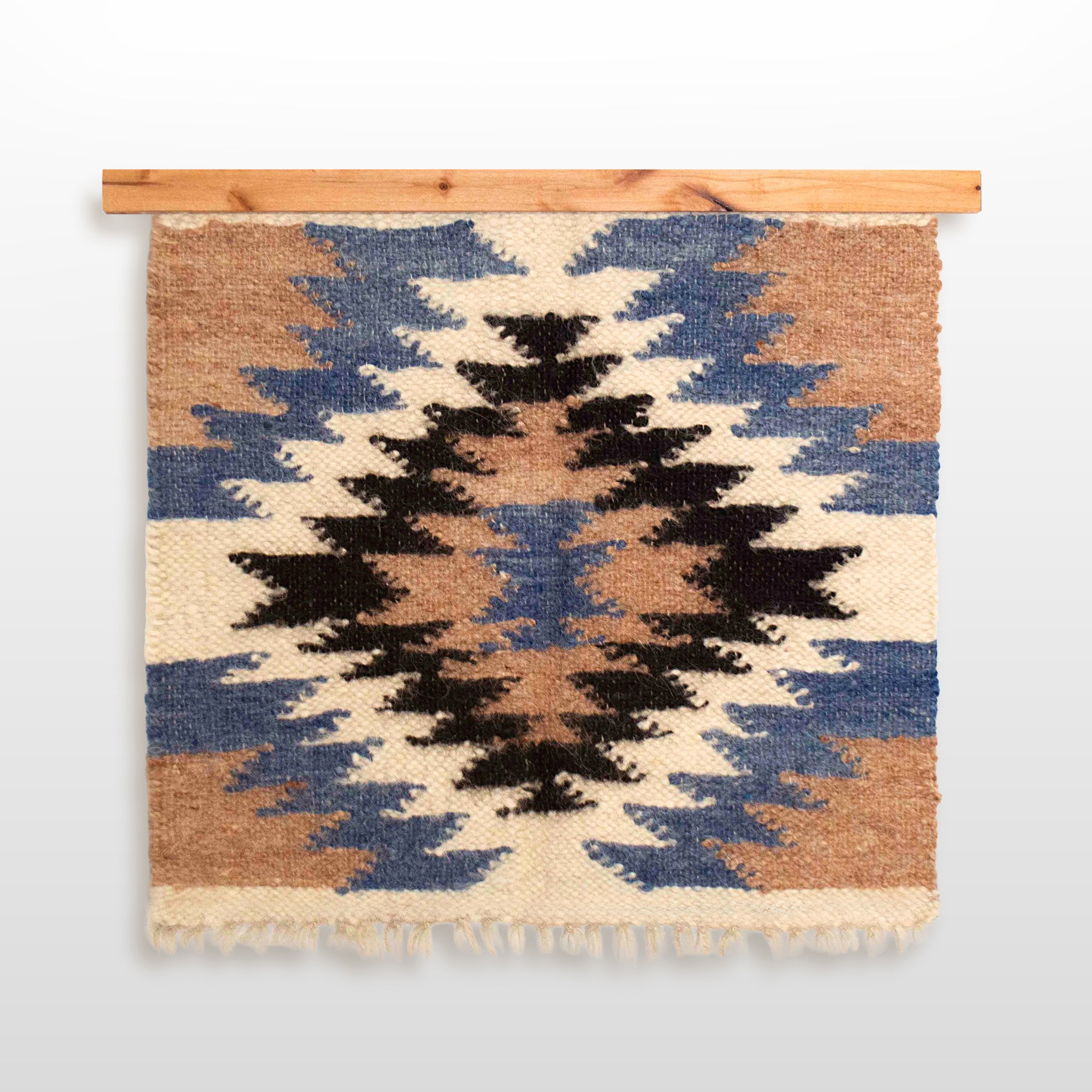Geometric diamond-patterned woven wall hanging in brown, black, cream, and blue, displayed on the Eco-Friendly Hemlock Wood Rug Quilt Hanger Wall Hanging Knobless for sustainable style.