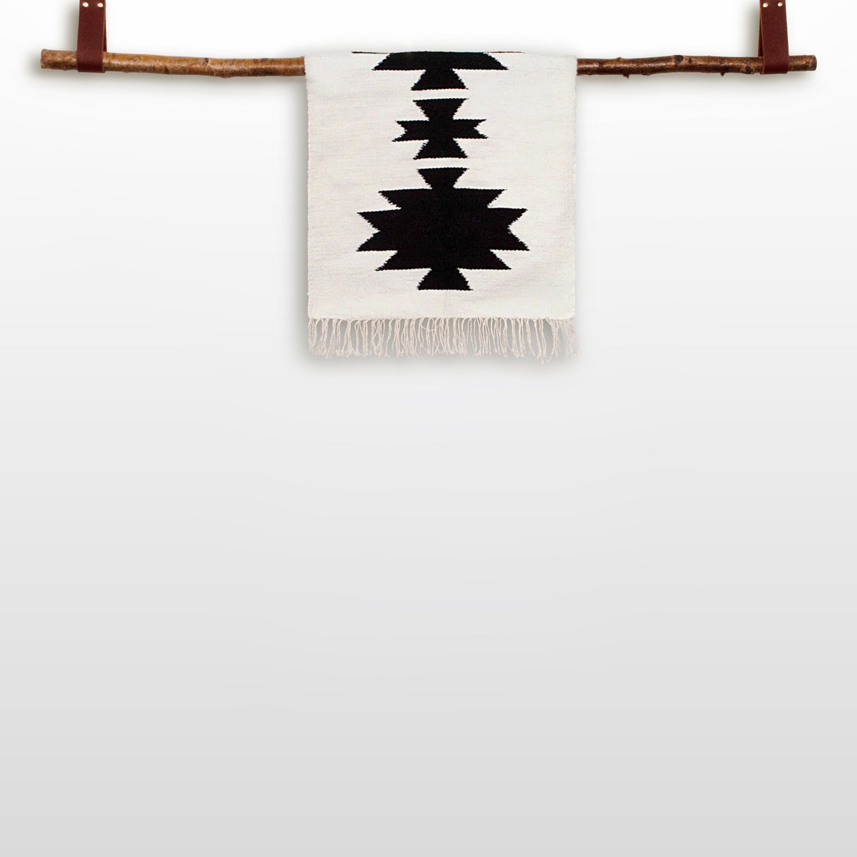 The Chysto (Pure) Wool Rug / Wall Hanging, shown with its Wood Rug Hanger ($240 value), features black and white geometric patterns and is crafted at an eco-friendly mill, displayed against a plain background.