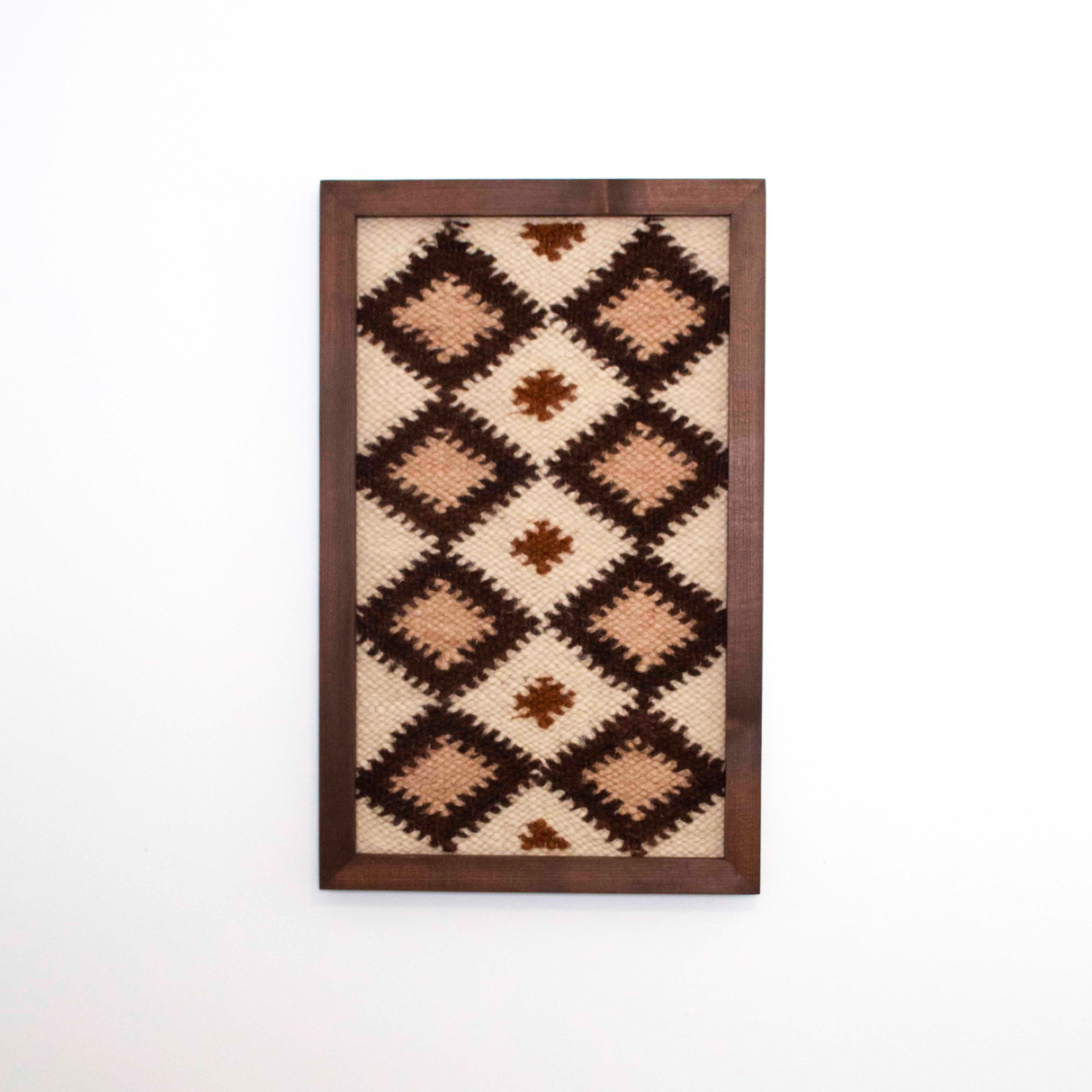Blazheny (Blissful) Wool Framed Wall Art features a geometric diamond pattern in brown, cream, and beige, set in a cedar frame for eco-friendly style—perfect for adding unique textile decor to any room.