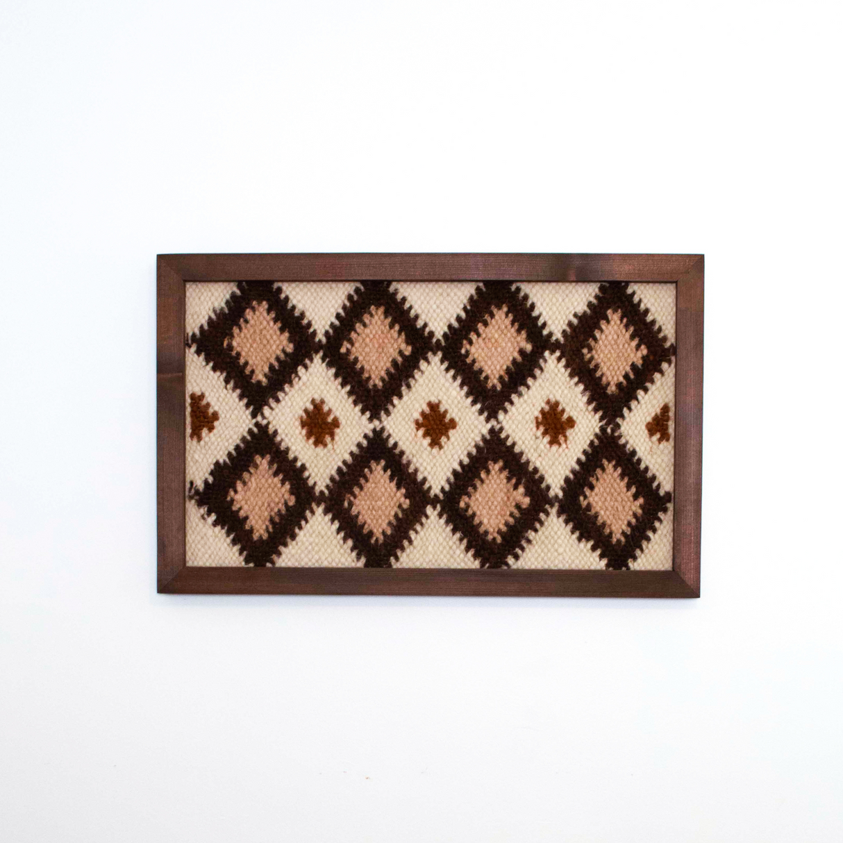 Blazheny (Blissful) Wool Framed Wall Art features a repeating diamond pattern in brown and beige, adding warmth and eco-friendly style to any space. Ideal for those seeking unique, sustainable wall decor.