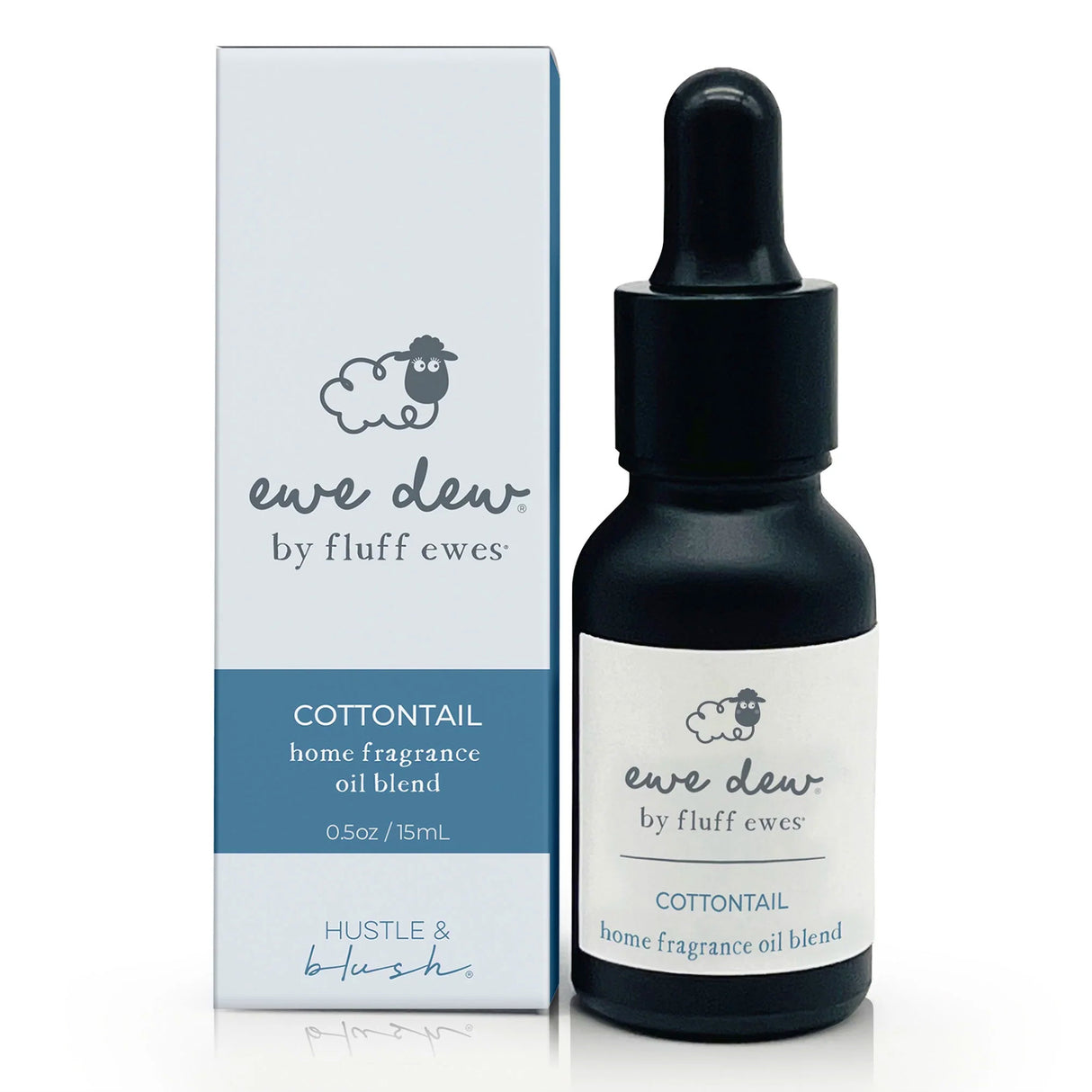 A 0.5oz dropper bottle and box of Ewe Dew by Fluff Ewes Cottontail Home Fragrance + Aromatherapy Essential Oil Blend (Clean & Crisp), ideal for wool dryer balls or diffuser, as a natural fabric freshener.