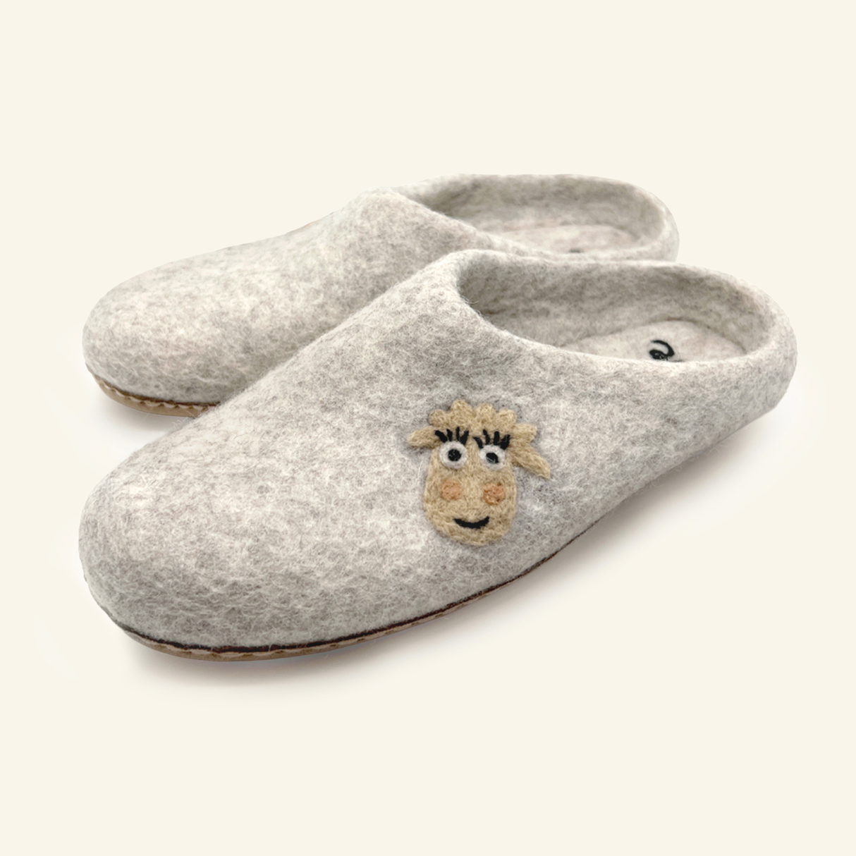 Love Ewe Hand-Felted Organic Wool Slippers for Men (Blush-LG) feature a cute sheep face design on the toes and are made from sustainable, organic wool.