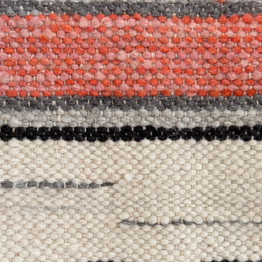 Close-up of the Chudovo (Well) Wool Statement Throw / Baby Blanket, handcrafted from Carpathian sheep wool with textured fibers and red, cream, gray, and black stripes inspired by traditional Ukrainian weaving.