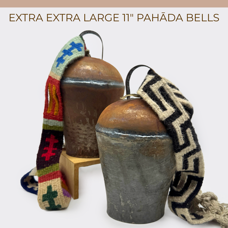 Two vintage handmade Pahāḍa Yak, Goat & Sheep's Bells from the Himalayan Mountains of Nepal and Tibet with colorful woven straps, shown on a white background. Perfect as Christmas ornaments, wreath decor, or for sound baths (11" bell).