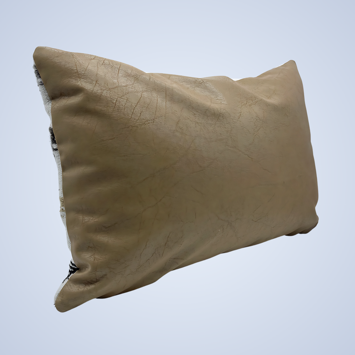 A Handwoven Promin (Beam) Wool Pillow in tan, showing visible cracks and frayed edges, rests against a light background.
