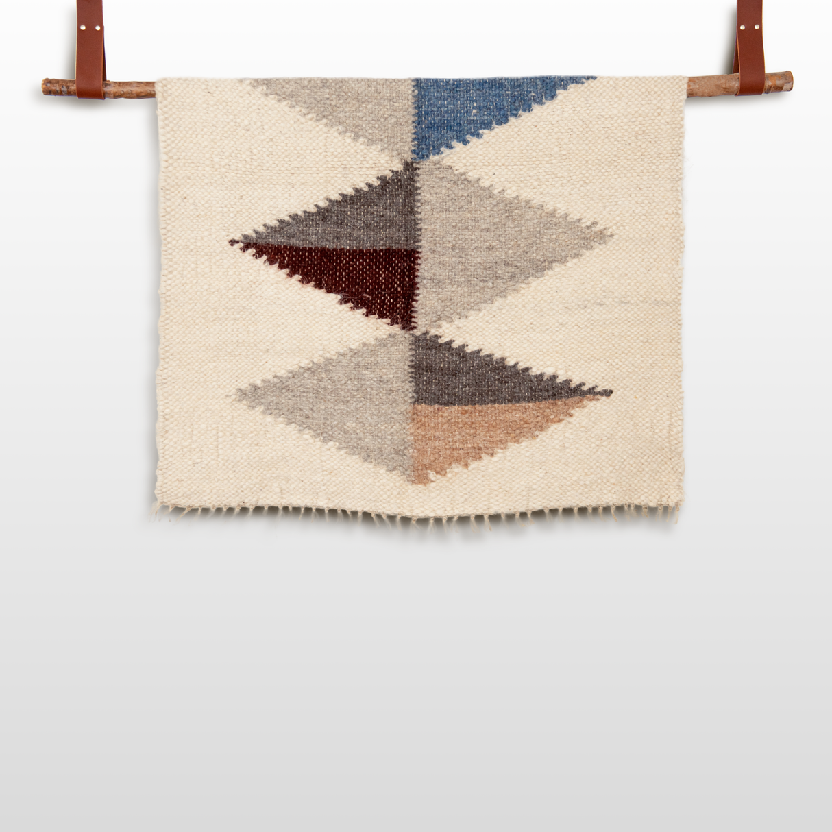 The Harmonia A (Harmony) Wool Statement Throw / Baby Blanket features geometric diamond patterns in blue, gray, brown, and beige—an artsy accent that adds cozy modern charm to your decor.