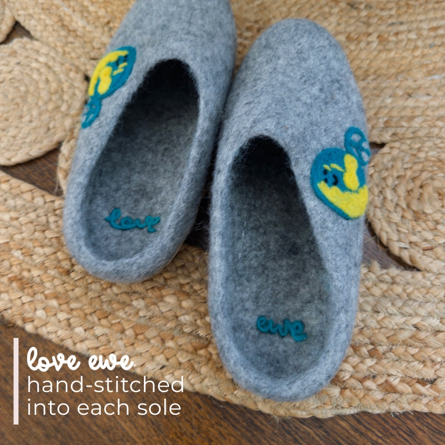 Love Ewe Hand-Felted Organic Wool Slippers for Men (Peace-LG): Gray, handmade from organic New Zealand wool with colorful heart patches and stitched "love" and "ewe" on a woven mat.