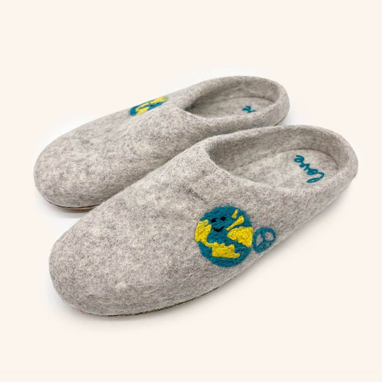 Love Ewe Hand-Felted Organic Wool Slippers for Women (Peace-DG) are gray slippers, handmade in Nepal, featuring an Earth and peace sign design embroidered on top.