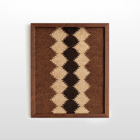 The Dobre (Good) Wool Framed Wall Art features a geometric zigzag pattern in brown, beige, and black on white—an artisanal woven textile perfect for elevating your decor.
