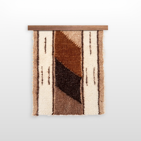 The Tak (Yes) Wool Bed / Couch Runner features brown, beige, and cream geometric patterns on a wooden rod—an ideal, sustainable choice for stylish home decor.