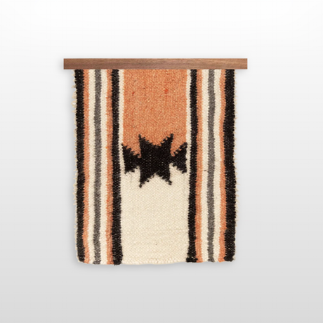 The Opora (Pillar) Wool Bed/Couch Runner is a handcrafted wall hanging with a black star pattern and orange, white, and black stripes—made from Carpathian sheep wool, it also works beautifully as a unique bed runner.