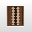 Dobre (Good) Wool Framed Wall Art—rectangular handwoven piece with zigzag beige, brown, and black patterns in a dark wood frame, perfect for organic wool decor enthusiasts.