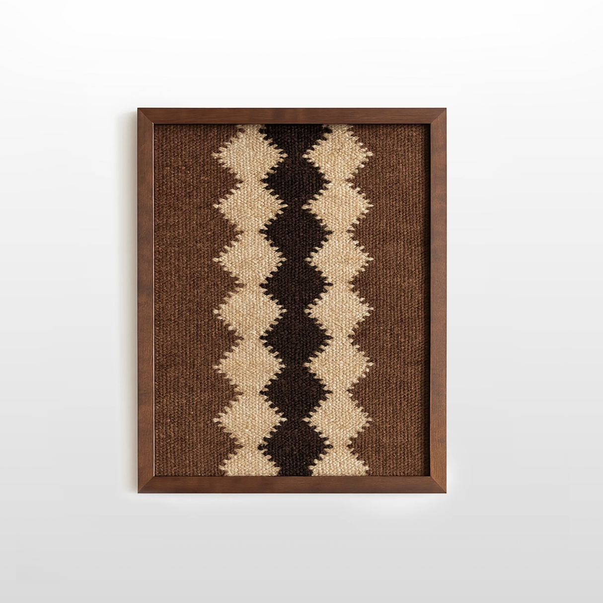 Dobre (Good) Wool Framed Wall Art—rectangular handwoven piece with zigzag beige, brown, and black patterns in a dark wood frame, perfect for organic wool decor enthusiasts.