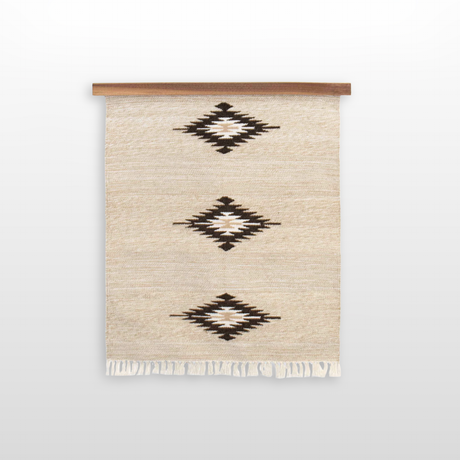 Chitki (Crisp) Wool Rug / Wall Hanging is handwoven from organic Carpathian wool with black geometric diamond patterns, fringe at the bottom, and comes with a wooden hanger ($240 value).