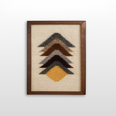 The Strilka (Arrow) Wool Framed Wall Art features five chevron shapes in brown, gray, black, and gold on a beige background, handwoven with organic wool for a warm, textured accent to your decor.