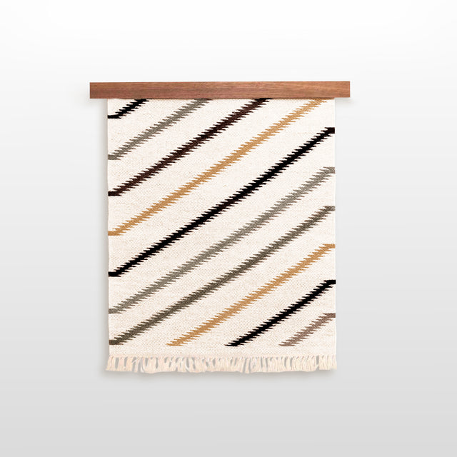 The Handmade in Ukraine Organic Natural 100% Sheep Wool Woven Rug Wall Hanging Decor features diagonal tan, black, and gray stripes with fringe, making it a stylish and eco-friendly accent for your space.