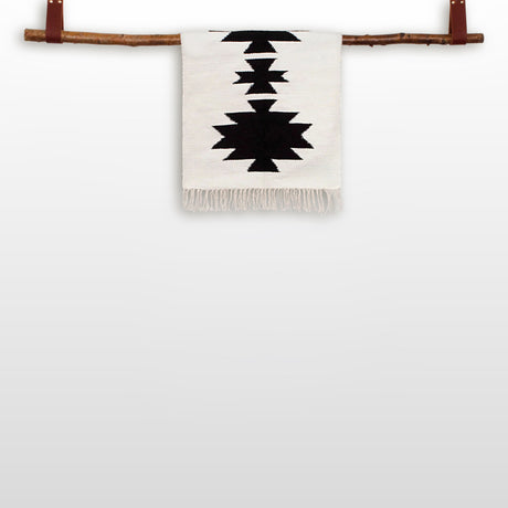 The "Handmade in Ukraine, Organic Natural 100% Sheep Wool Woven Rug Wall Hanging Decor" features black geometric patterns on white wool, handcrafted by Ukrainian artisans and displayed on a wooden rod.