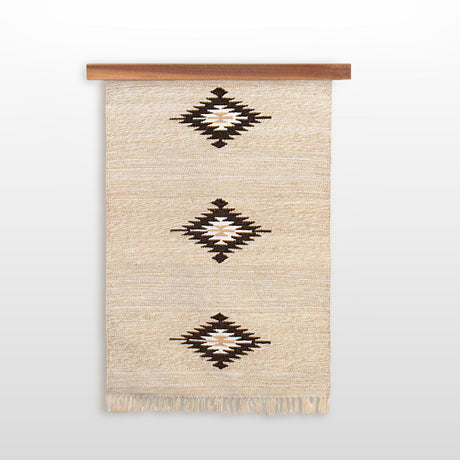 Beige woven wall hanging with three black geometric diamond patterns and fringed ends, displayed on the Eco-Friendly Hemlock Wood Rug Quilt Hanger Wall Hanging Knobless for a sustainable accent.