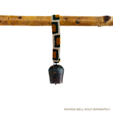 A metal bell with a Medium Strap for Hanging Vintage Bells hangs from a wooden branch; text reads "PAHĀḌA BELL SOLD SEPARATELY.