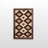 Blazheny (Blissful) Wool Framed Wall Art features a geometric diamond design in brown, beige, and cream on a white background, crafted from organic wool.