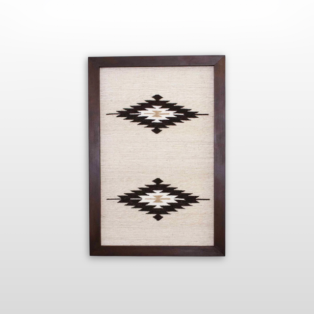 Wool Rug Framed Wall Art, handwoven from Carpathian wool, showcases two black and white geometric diamond patterns on a cream background—an elegant and sustainable home decor accent.