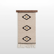 Handmade in Ukraine, this organic 100% sheep wool woven wall hanging decor features three geometric diamond patterns and fringe, crafted by artisans and displayed on a wooden rod.