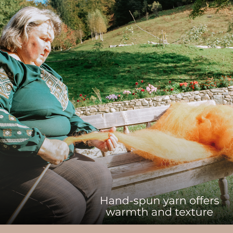 An older woman spins orange Carpathian sheep wool into yarn near a stone wall, preserving traditions with every Chudovo (Well) Wool Statement Throw / Baby Blanket she lovingly handcrafts outdoors.