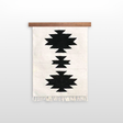 The Chysto (Pure) Wool Rug / Wall Hanging features black geometric patterns on white, inspired by Ukrainian weaving heritage. Includes wood rug hanger ($240 value). Finished with fringe at the bottom.