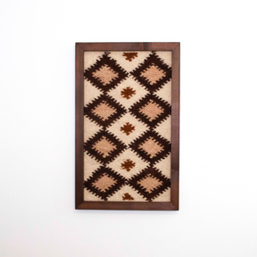 Blazheny (Blissful) Wool Framed Wall Art features a geometric diamond pattern in brown, cream, and beige, set in a cedar frame for eco-friendly style—perfect for adding unique textile decor to any room.