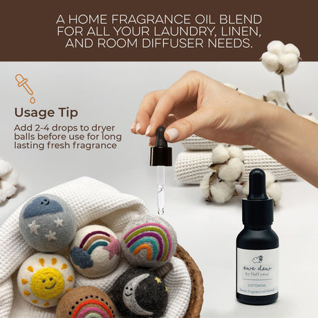A hand adds fragrance oil to Fluff Ewes Premium XL Dryer Balls: "Sheep in Heavenly Peace" 6 Pack, Holiday Limited Edition, with a bottle and cotton stems nearby, offering a natural, eco-friendly fabric softener alternative.