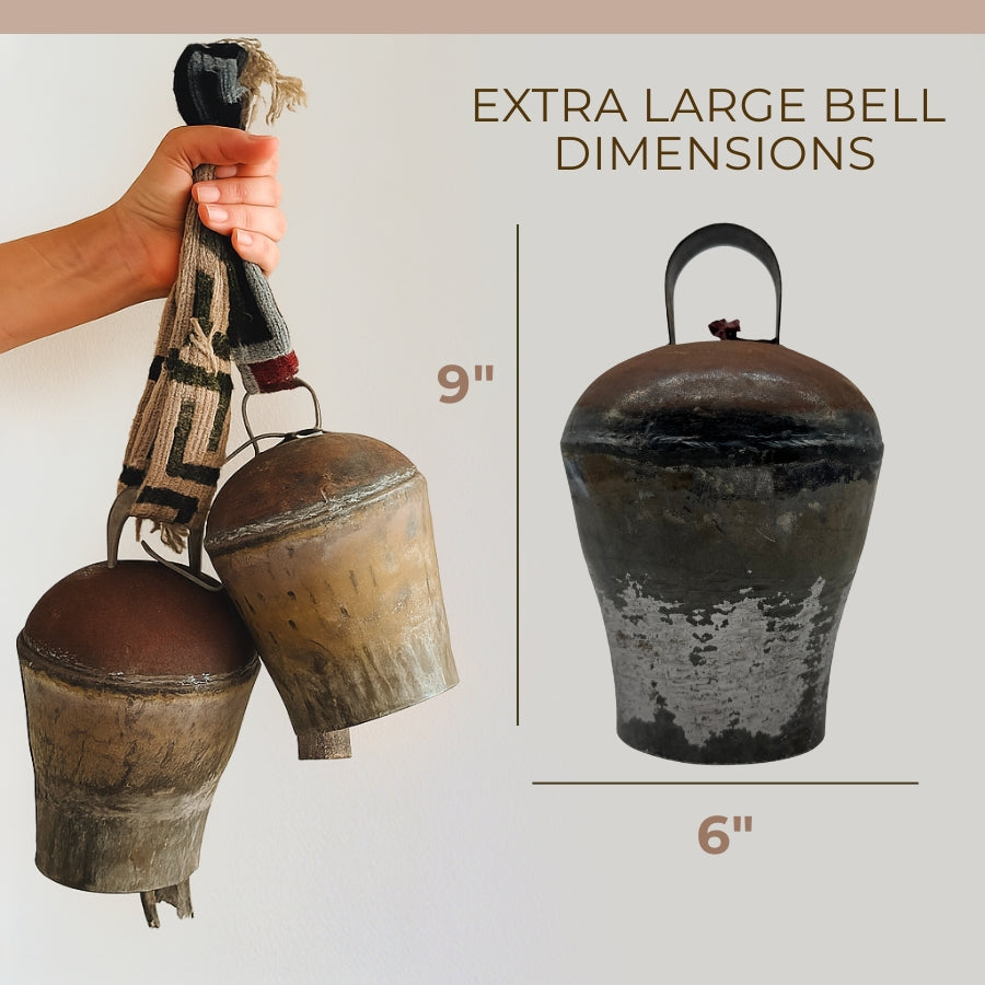 Hand holding Vintage Handmade Pahāḍa Yak, Goat & Sheep's Bell from the Himalayas; shown is a single extra large 9" x 6" bell. Handcrafted in Nepal, fair trade. Ideal for Christmas, wreath décor, or sound bath.
