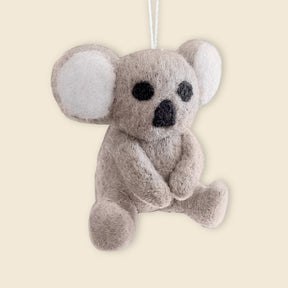 The Hand-Stitched Felted Koala Ornament features a small plush koala with white ears, hanging by a string—ideal handmade felt decor for your holiday celebrations.