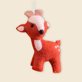 The Hand-Stitched Felted Large Deer Ornament features white spots and hangs by a string—ideal for anyone who loves charming wool Christmas decorations.