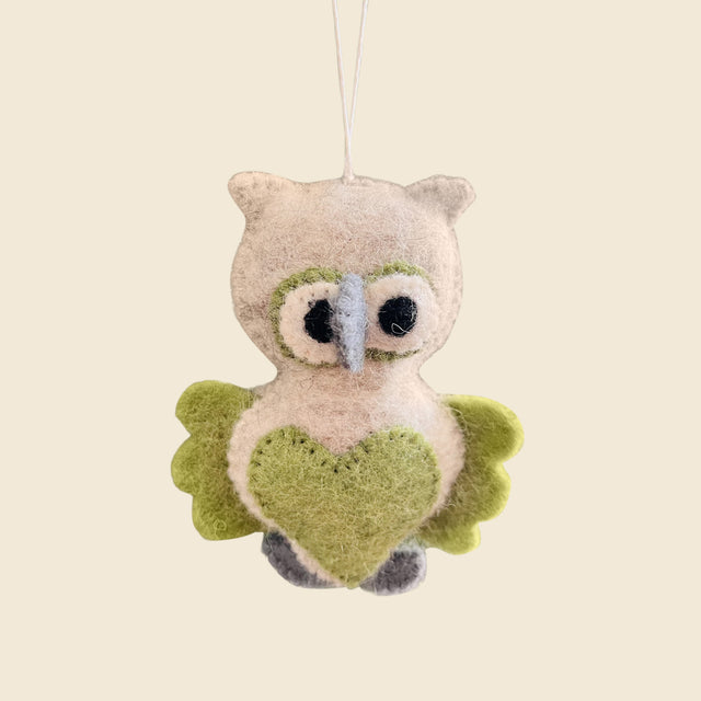 Hand-Stitched Felted Owl Ornament with green wings and a heart-shaped belly, hanging on a string. This whimsical wool ornament brightens up any artisan Christmas ornaments collection.