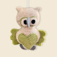 The Hand-Stitched Felted Owl Ornament features green wings, a heart-shaped belly, and soft felt details. Hanging by a white string, it's an adorable artisan Christmas ornament for your collection.