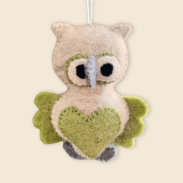 The Hand-Stitched Felted Owl Ornament features green wings, a heart-shaped belly, and soft felt details. Hanging by a white string, it's an adorable artisan Christmas ornament for your collection.