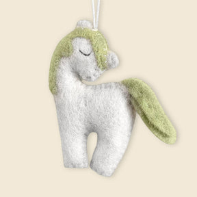 Hand-Stitched Felted Small Unicorn Ornament: Features a green wool mane and tail, closed eyes, and a hanging loop—an artisan Christmas decoration shown on a beige background.