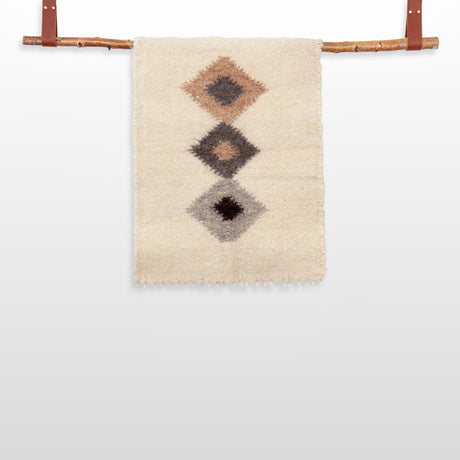The Harny (Beautiful) Wool Framed Wall Art features three diamond designs on woven fabric, displayed on a handcrafted cedar frame with leather straps—ideal as nursery décor or stylish wall art.