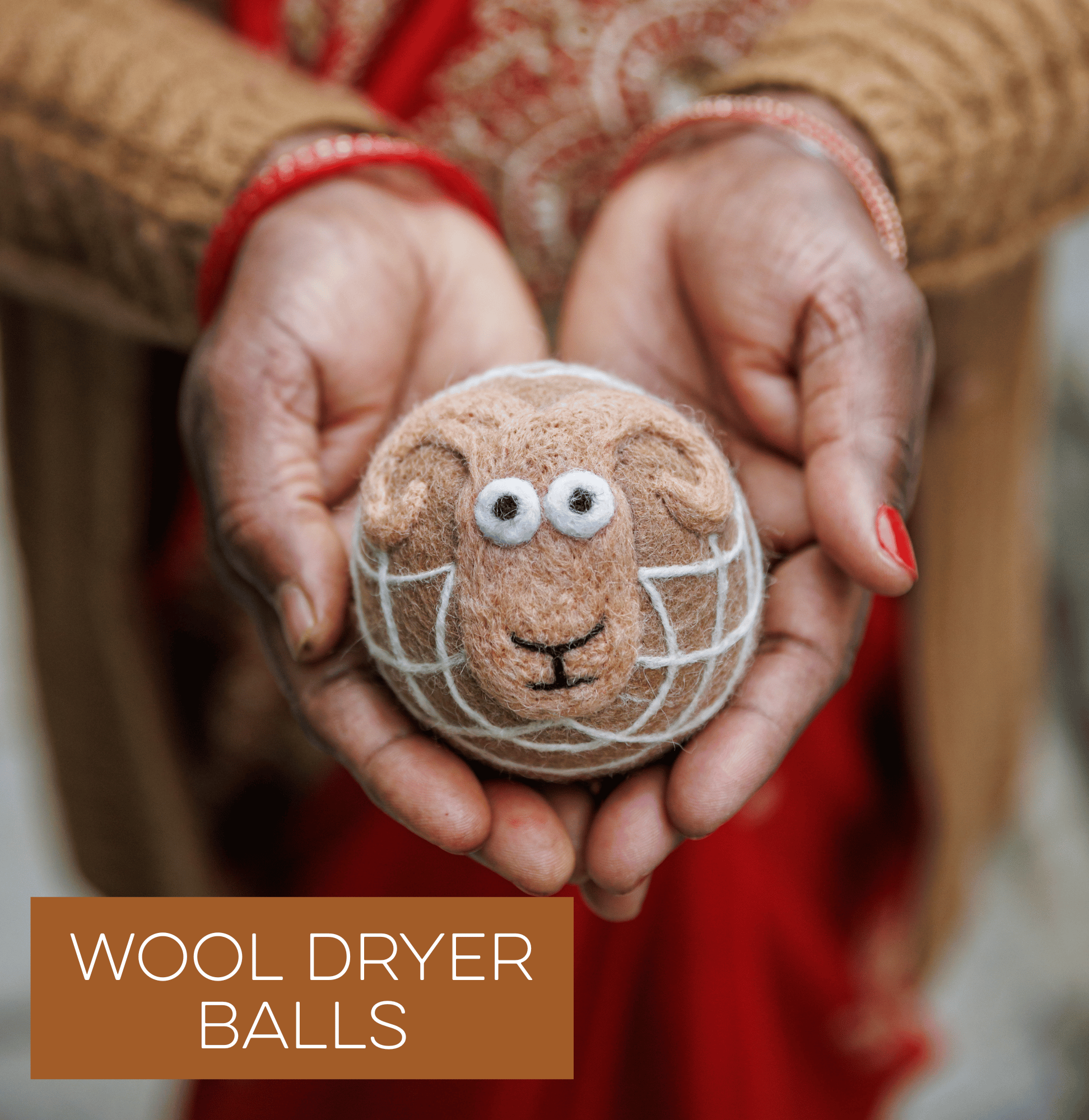 Hands holding a wool dryer ball with a sheep face design; text reads 