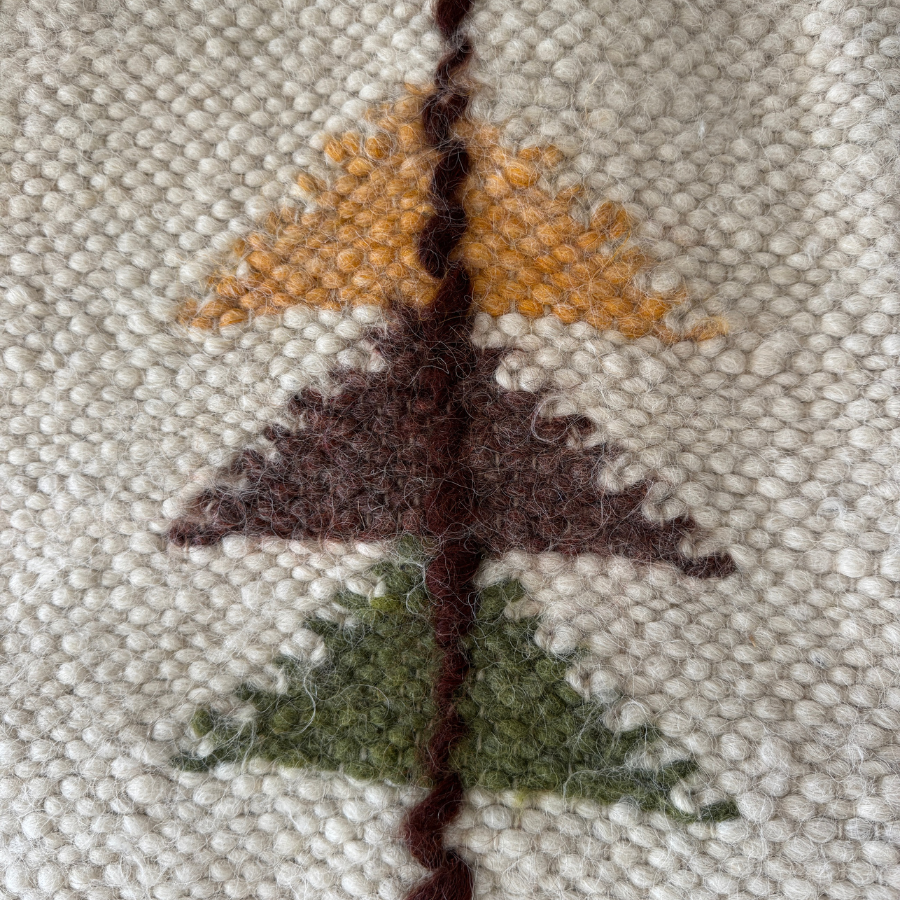 The Lis (Forest) Wool Statement Throw / Baby Blanket features three stacked triangles in yellow, brown, and green on a textured cream background, crafted from soft Carpathian wool.