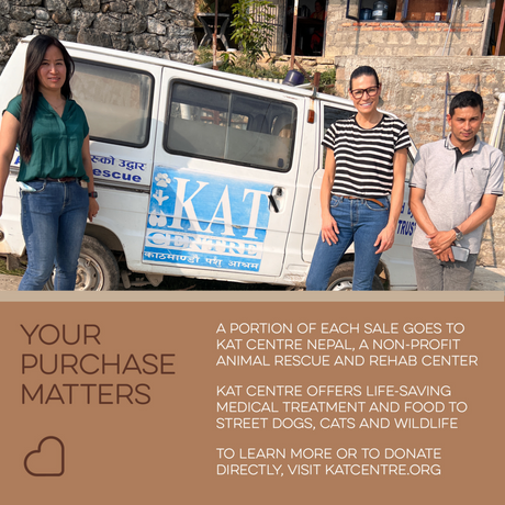 Three people stand by a KAT Centre animal rescue van. A sign shares that buying Love Ewe Handmade Felt Pet Toys (natural dye, 3-pack) helps support essential animal care and the planet.