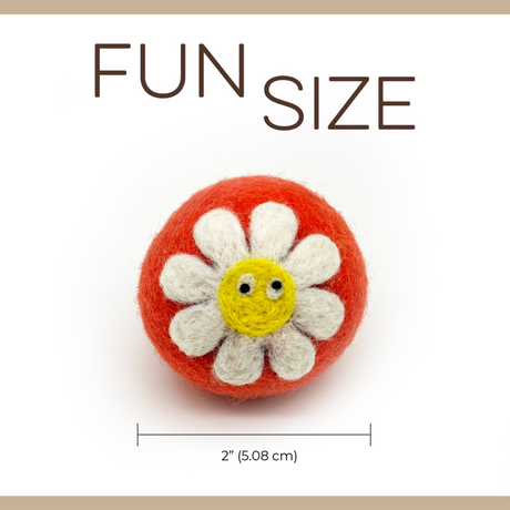 A small, round, white and yellow felt flower from Love Ewe Handmade Felt Pet Toys (3-Pack), crafted with planet-friendly, natural dye New Zealand wool for cats, kittens, dogs, and small pets—Save the Bees.