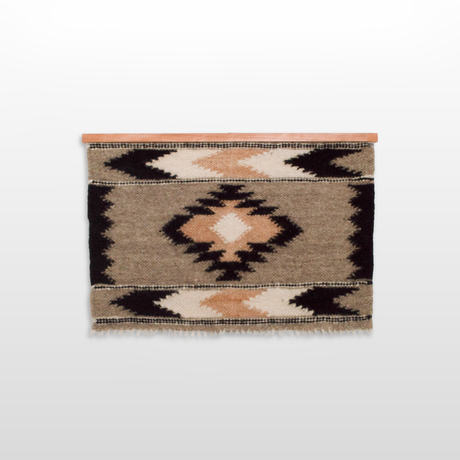 The Myr (Peace) Wool Wall Hanging is handcrafted with geometric patterns in beige, brown, and black, woven from undyed yarn and displayed on a wooden rod.