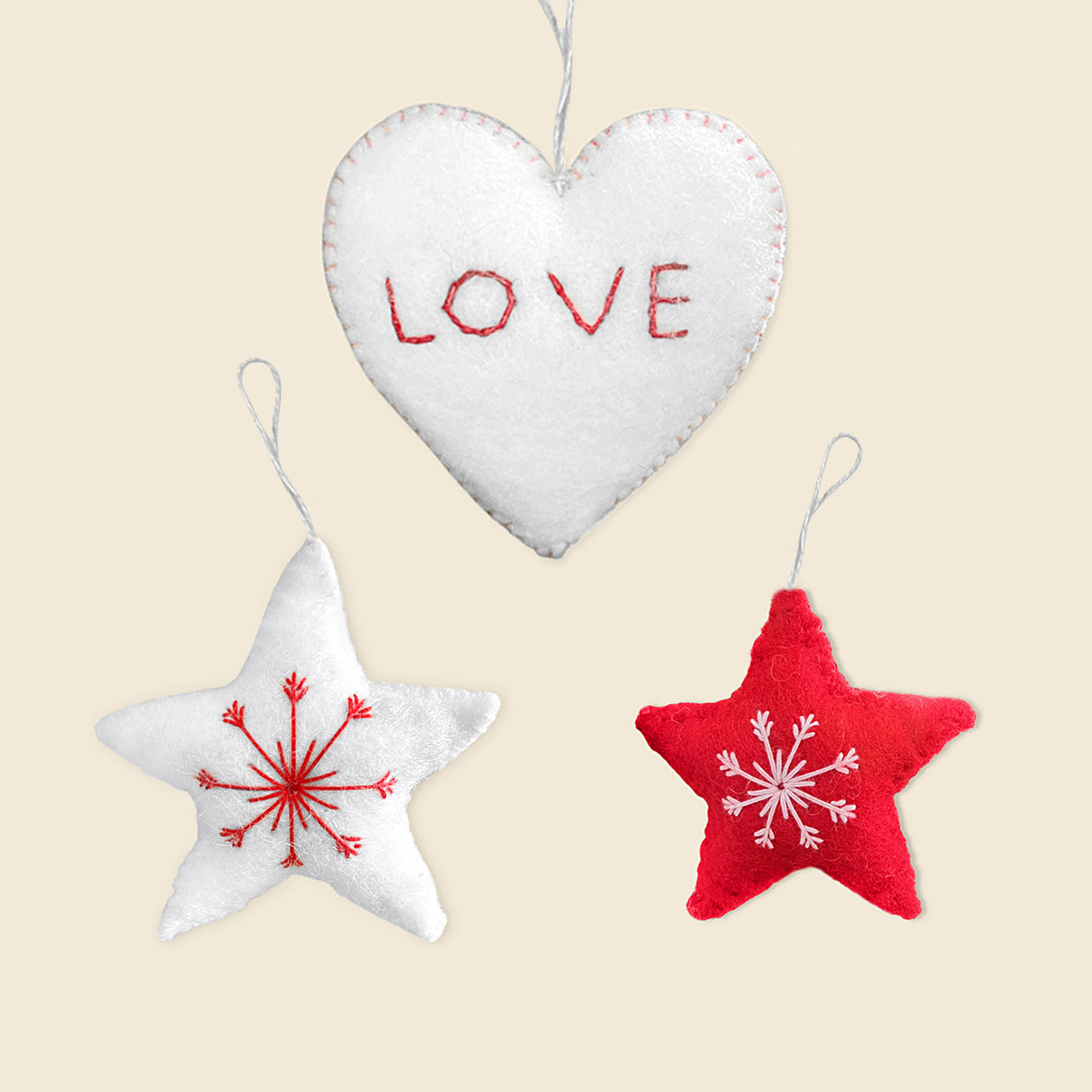 Trio of Hand-Stitched Felt Stars and Heart Ornaments: includes a white heart with "LOVE" and two stars, one white, one red, each with embroidered designs. Beautiful artisan Christmas ornaments handcrafted in Nepal.
