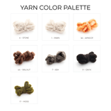 Seven labeled yarn samples in stone, fawn, apricot, walnut, ash, onyx, and moss—ideal hues to create your own Mudry (Wise) Wool Statement Baby Blanket or a cozy multi-colored throw.