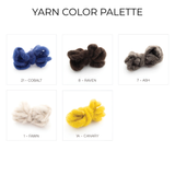 Five yarn skeins in cobalt blue, brown, gray, off-white, and yellow—each labeled with its color name—are perfect for crafting a Zoloty (Golden) Wool Statement Bed Blanket or another stunning statement blanket.