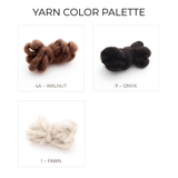 The Dobre (Good) Wool Framed Wall Art features three yarn skeins in Walnut (brown), Onyx (black), and Fawn (cream)—ideal shades for crafting striking geometric patterns or unique art pieces for your space.