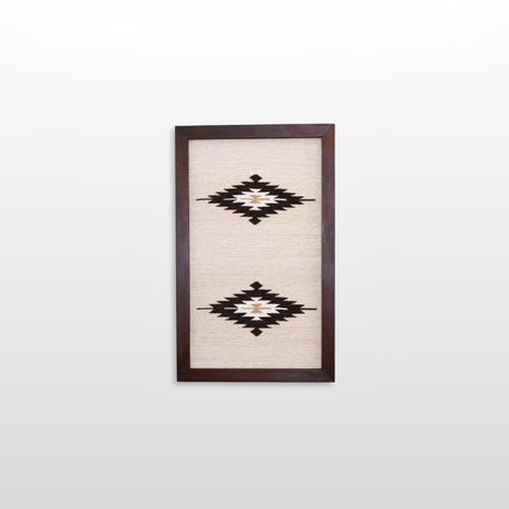 The Wool Rug Framed Wall Art showcases two black and white geometric diamond patterns on a light background, perfect for adding minimalist, eco-friendly decor to any space.